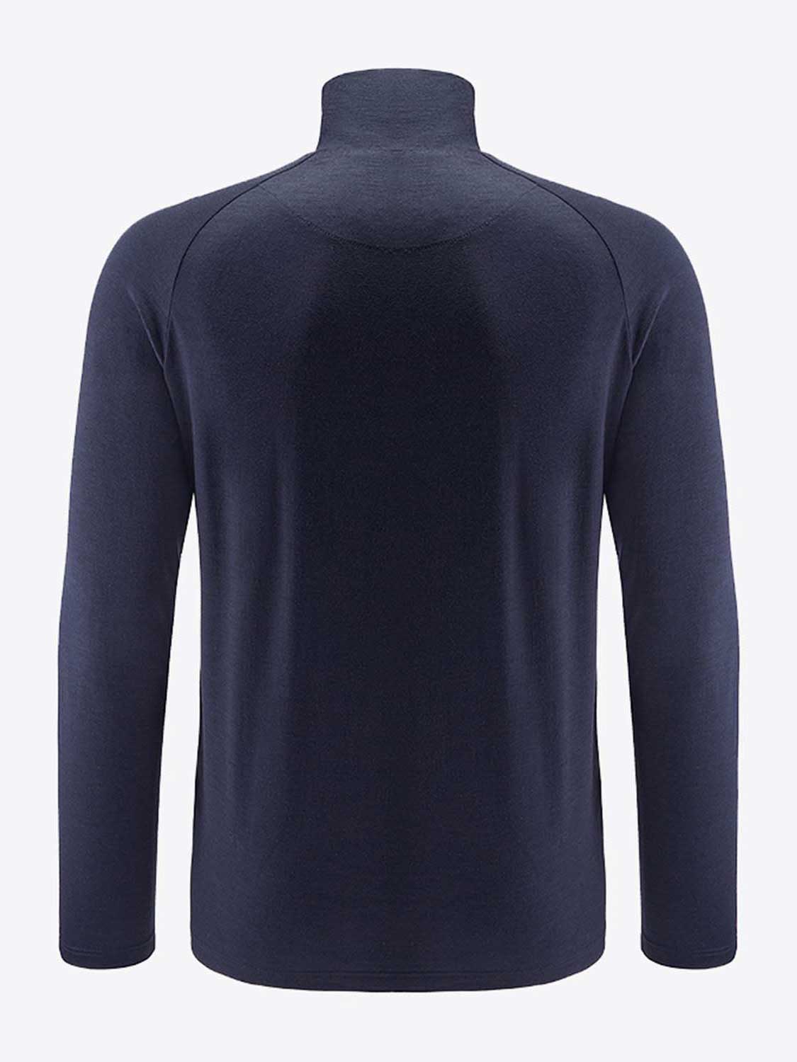 The Sno Merino Zip Up Men by We Norwegians is depicted from the back, showcasing its long sleeves and dark navy blue hue. Made from breathable merino wool, the fabric appears smooth and slightly fitted with no visible patterns or designs. The light grey backdrop contrasts beautifully with the shirt's dark color, epitomizing true Scandinavian luxury in base-layers.