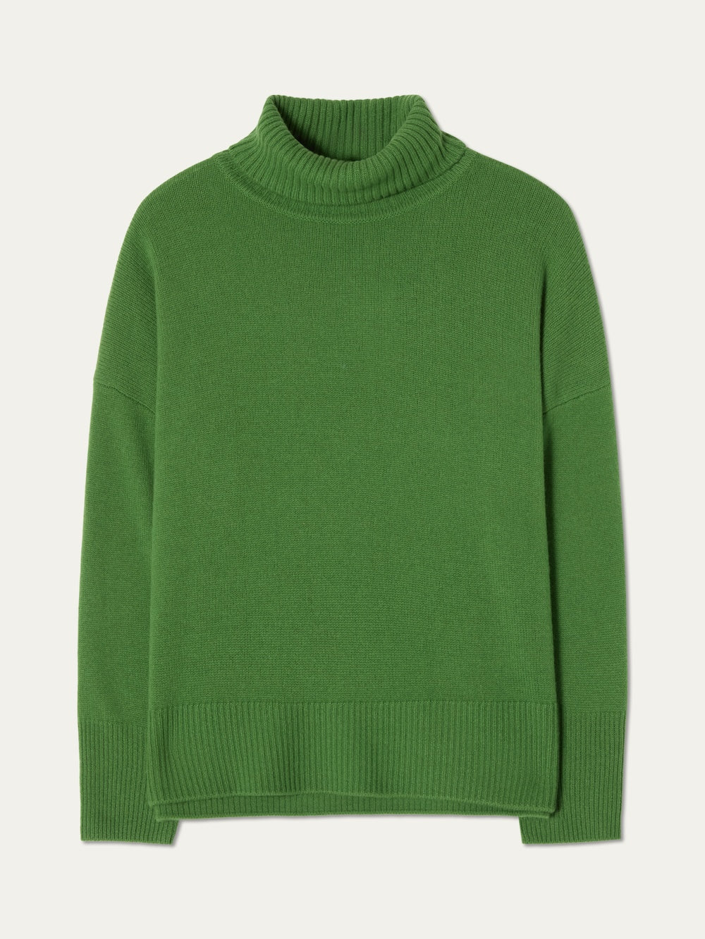 The Blefjell Sweater Women by We Norwegians—crafted from pure cashmere in green with long sleeves and ribbed cuffs, hem, and collar—offers an elegant luxury knitwear option, shown flat on a cream background.