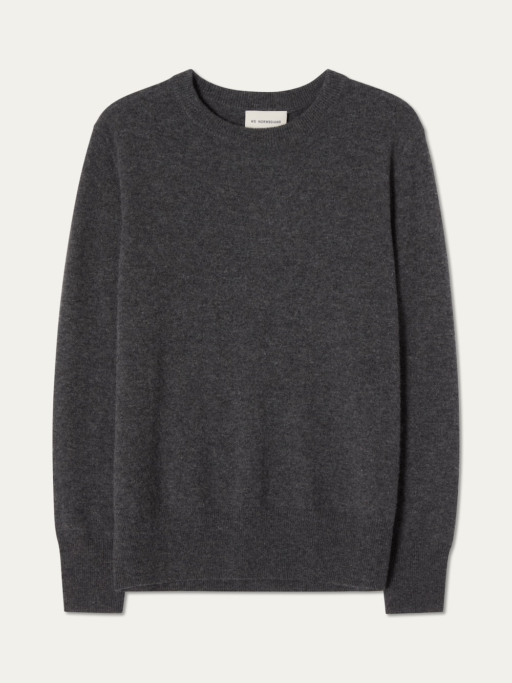 The We Norwegians Blefjell Crewneck Women - Pure Cashmere is a dark gray, ultra-soft 100% cashmere long-sleeve sweater with a classic crewneck, shown laid flat on a light background.
