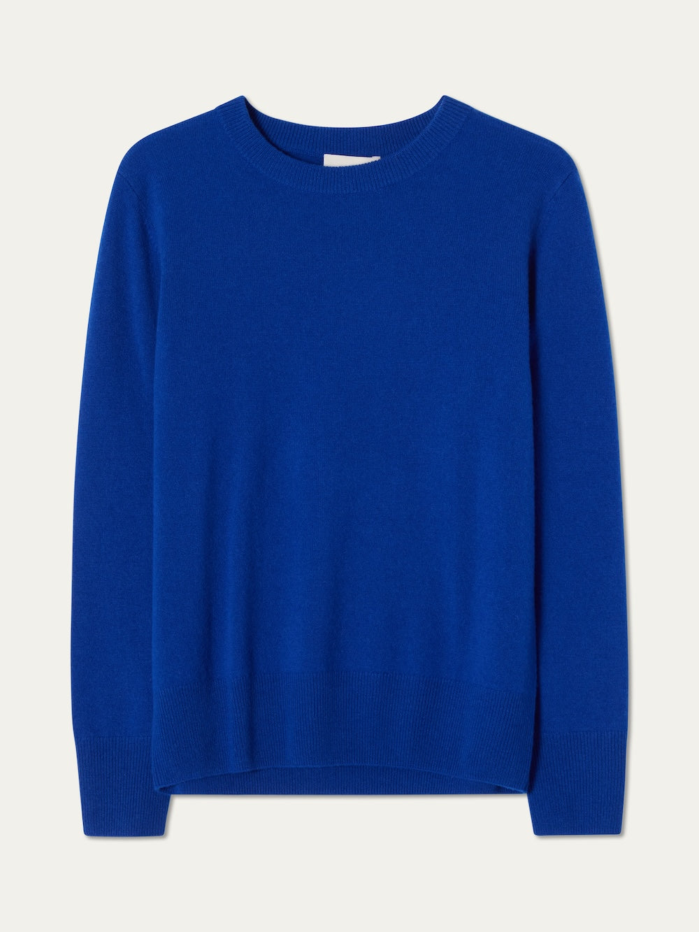The We Norwegians Blefjell Crewneck Women is a pure cashmere, long-sleeved sweater in solid bright blue with a crew neck, shown laid flat on a light background.
