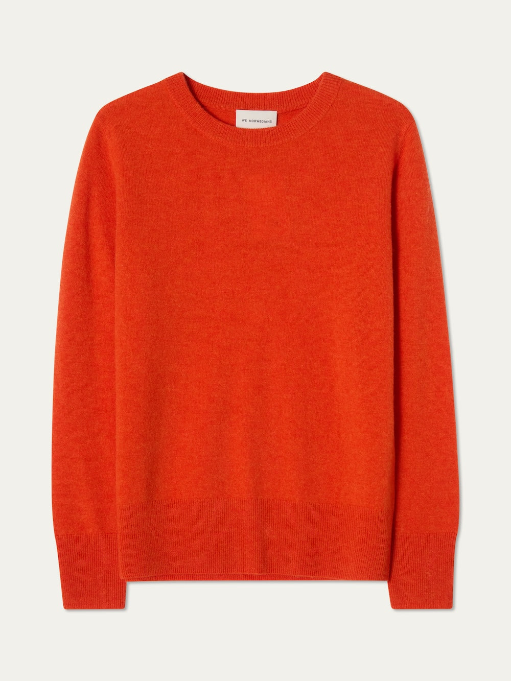 The We Norwegians Blefjell Crewneck Women - Pure Cashmere sweater in bright orange is shown laid flat on a light background. This 100% cashmere, long-sleeve piece features ribbed cuffs, hem, and neckline with no visible patterns or logos.