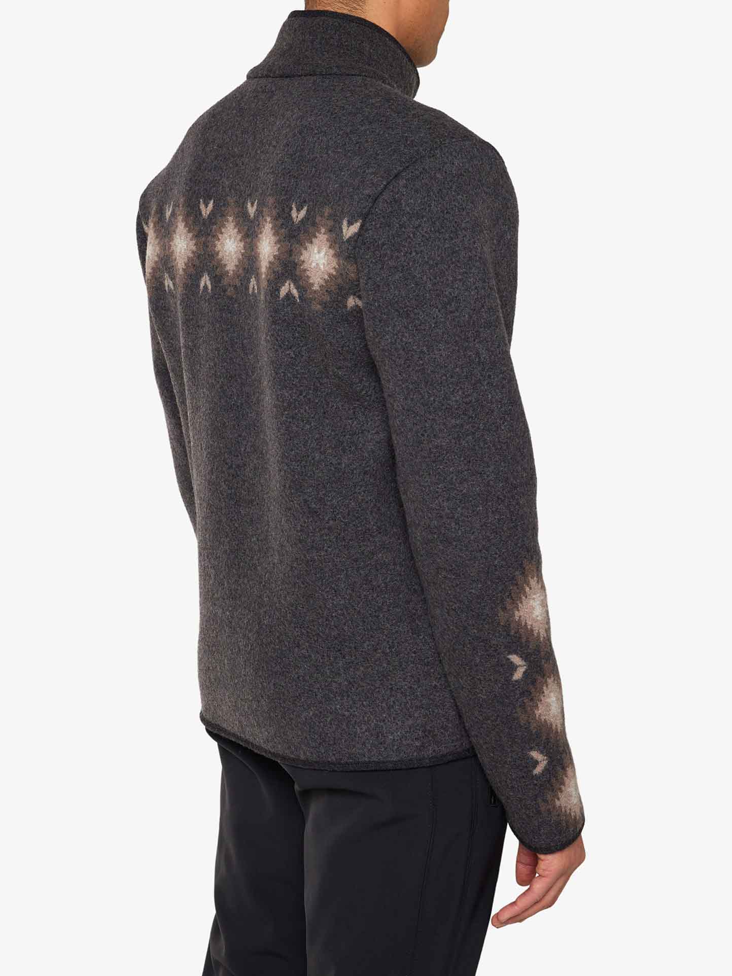 We Norwegians_FW25_Mens | Model is wearing the Hovden jacket | Color: Black | The jacket has a two-way zipper with a striking jacquard pattern inspired the Norwegian Sámi culture | Back view against a white background