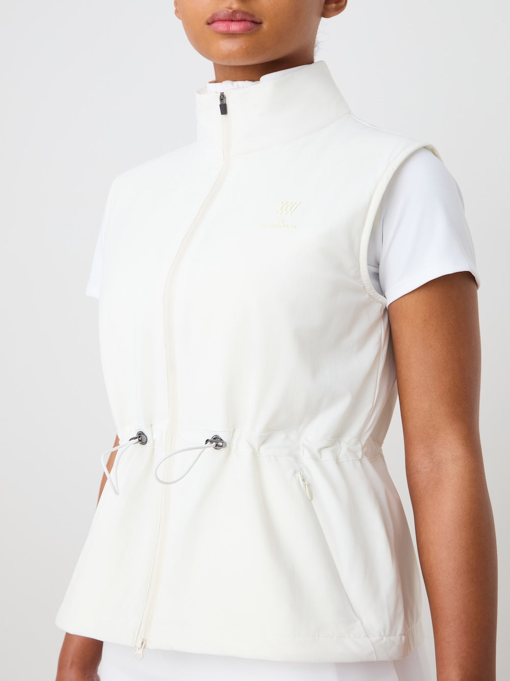 White vest worn by a person on a light background