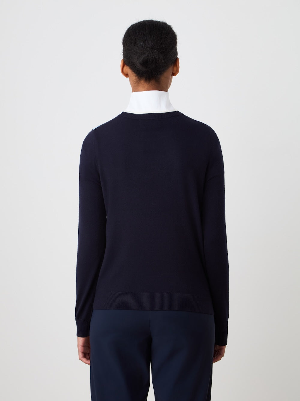 Person wearing the navy blue Fairway sweater over a white shirt with a plain background_Back