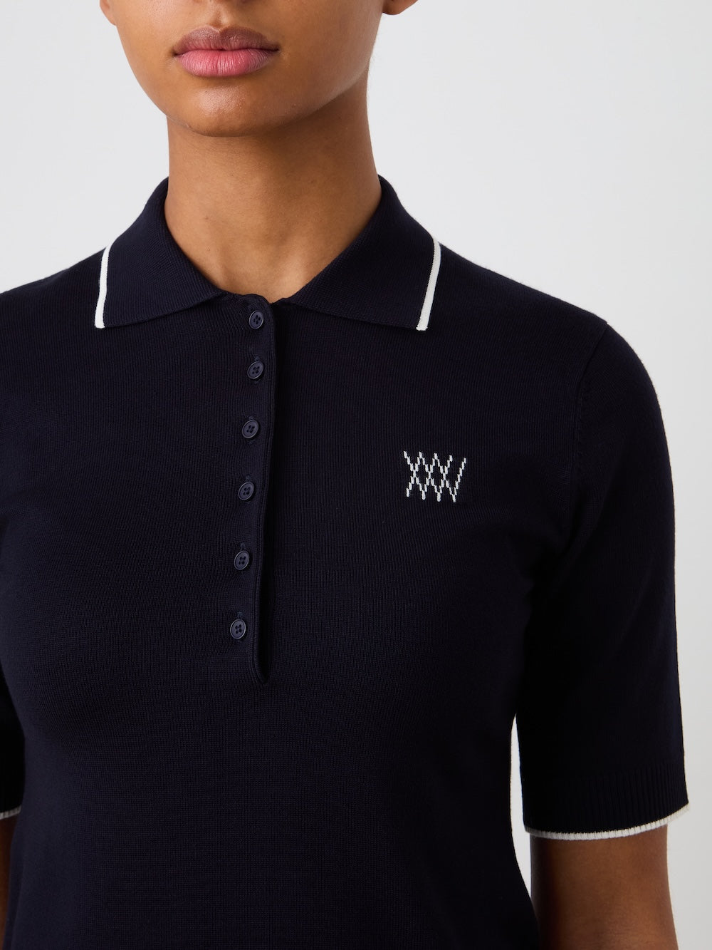 Navy blue polo shirt with a logo on a plain background