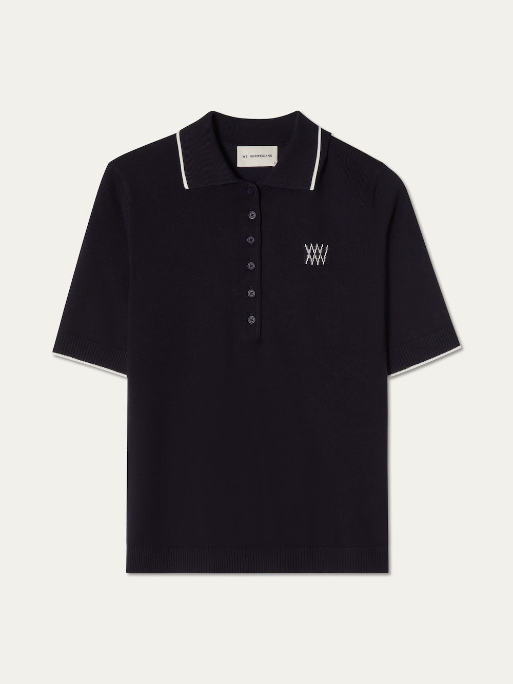 Navy blue polo shirt with white trim on an off white background