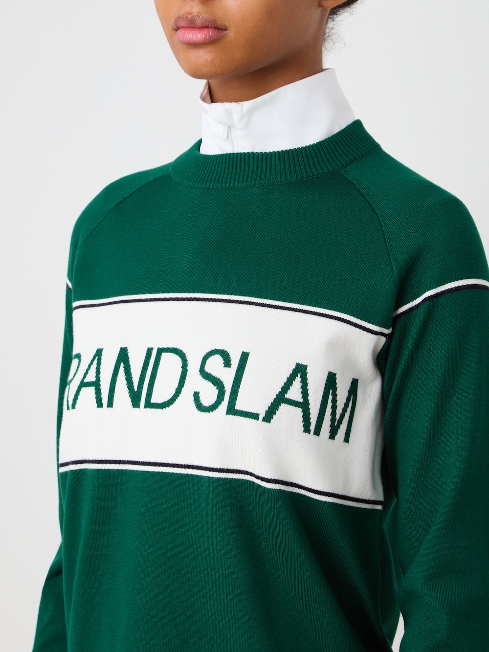 Green sweater with 'GRAND SLAM' text on a light background
