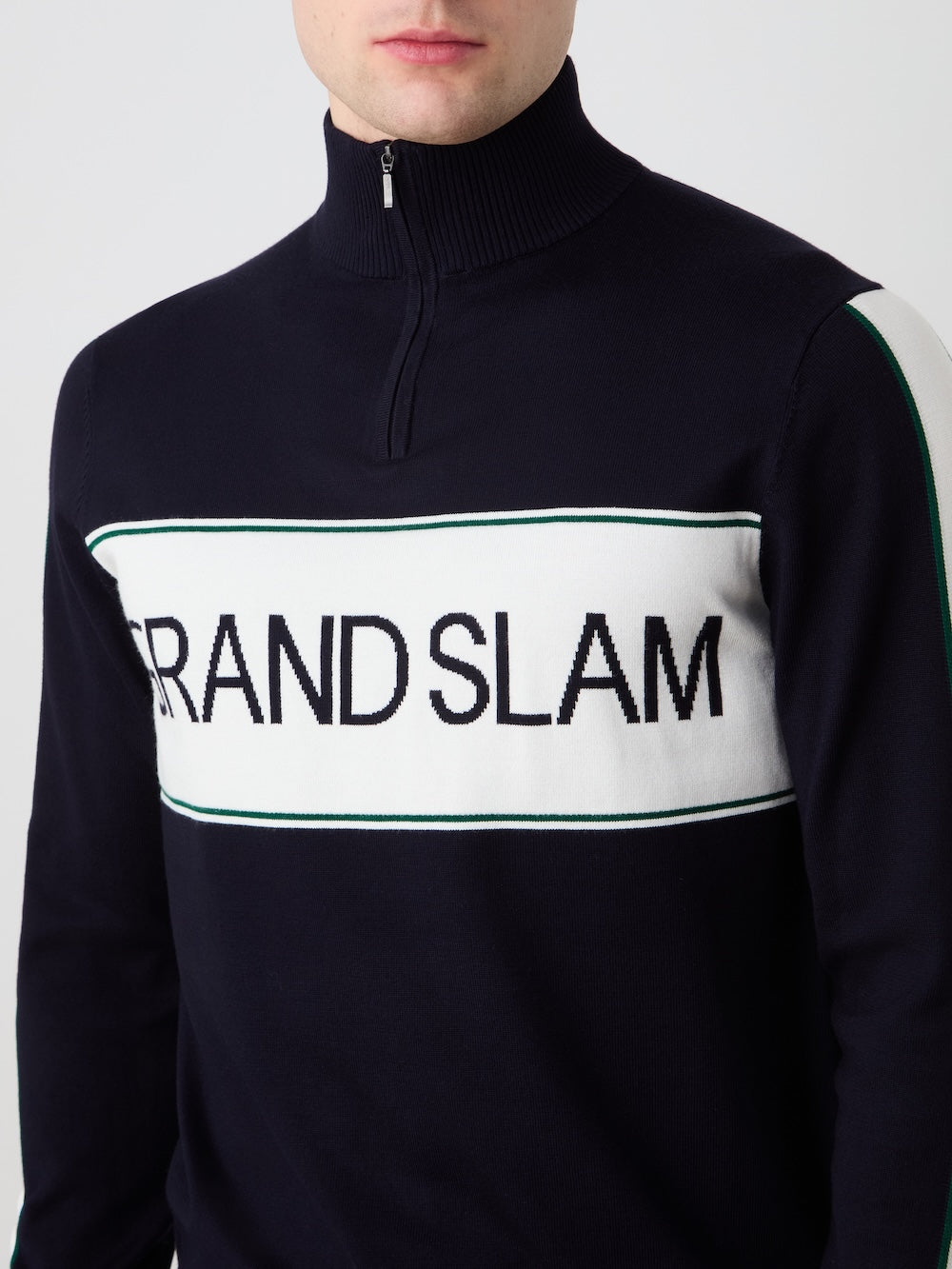 Person wearing a navy blue sports sweater with 'Grand Slam' branding.