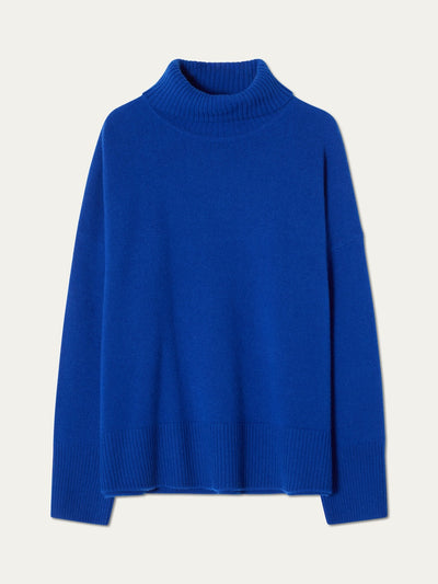 The We Norwegians Blefjell Sweater Women—pure cashmere in bright blue—features long sleeves, ribbed cuffs, hem, and neck, shown flat on a plain light background.