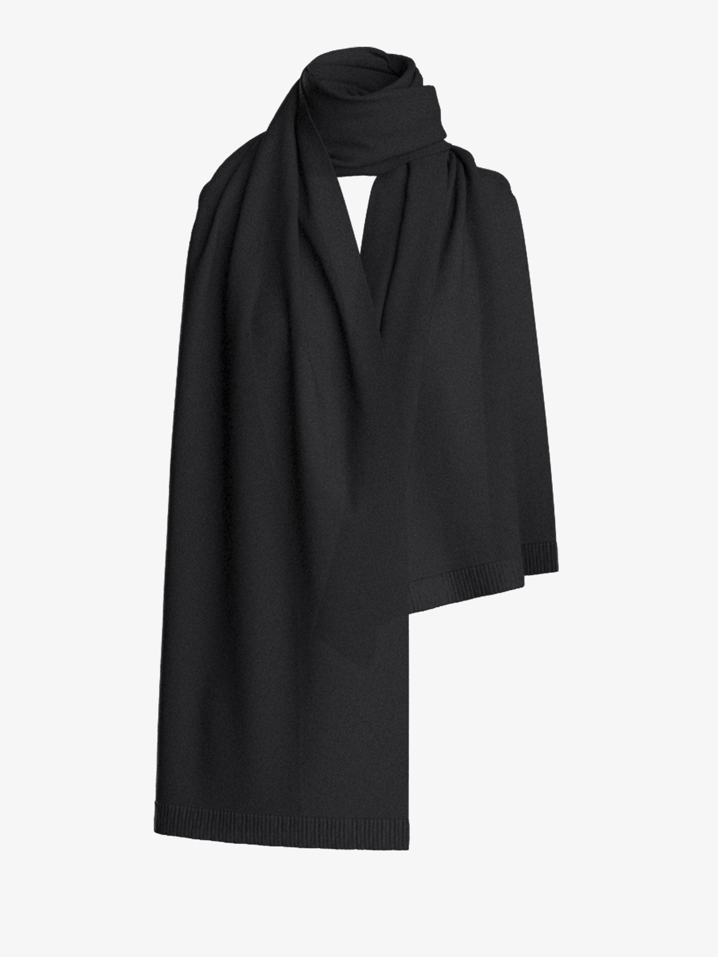 The Blefjell Scarf from We Norwegians is elegantly draped against a plain white background. This large cashmere scarf looks soft and finely woven, with a subtle texture and smooth edges, creating a minimalist and sophisticated appearance.