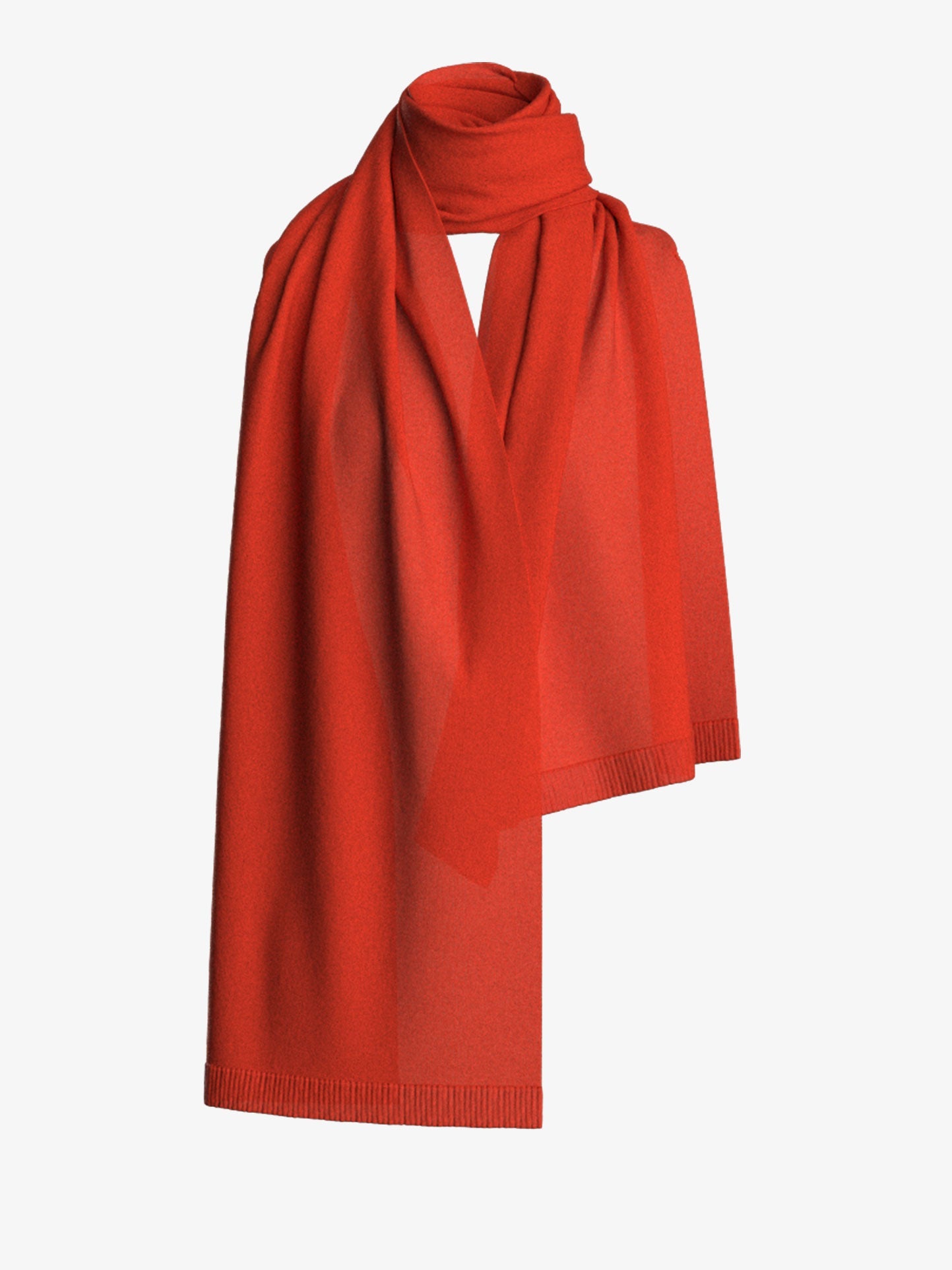 The Blefjell Scarf by We Norwegians, in a vibrant red hue, is gracefully displayed with its soft and smooth texture. Its elegant length and minimalist design are showcased beautifully, while the neatly hemmed edges provide an extra touch of sophistication. The plain white background enhances the scarf's refined allure.