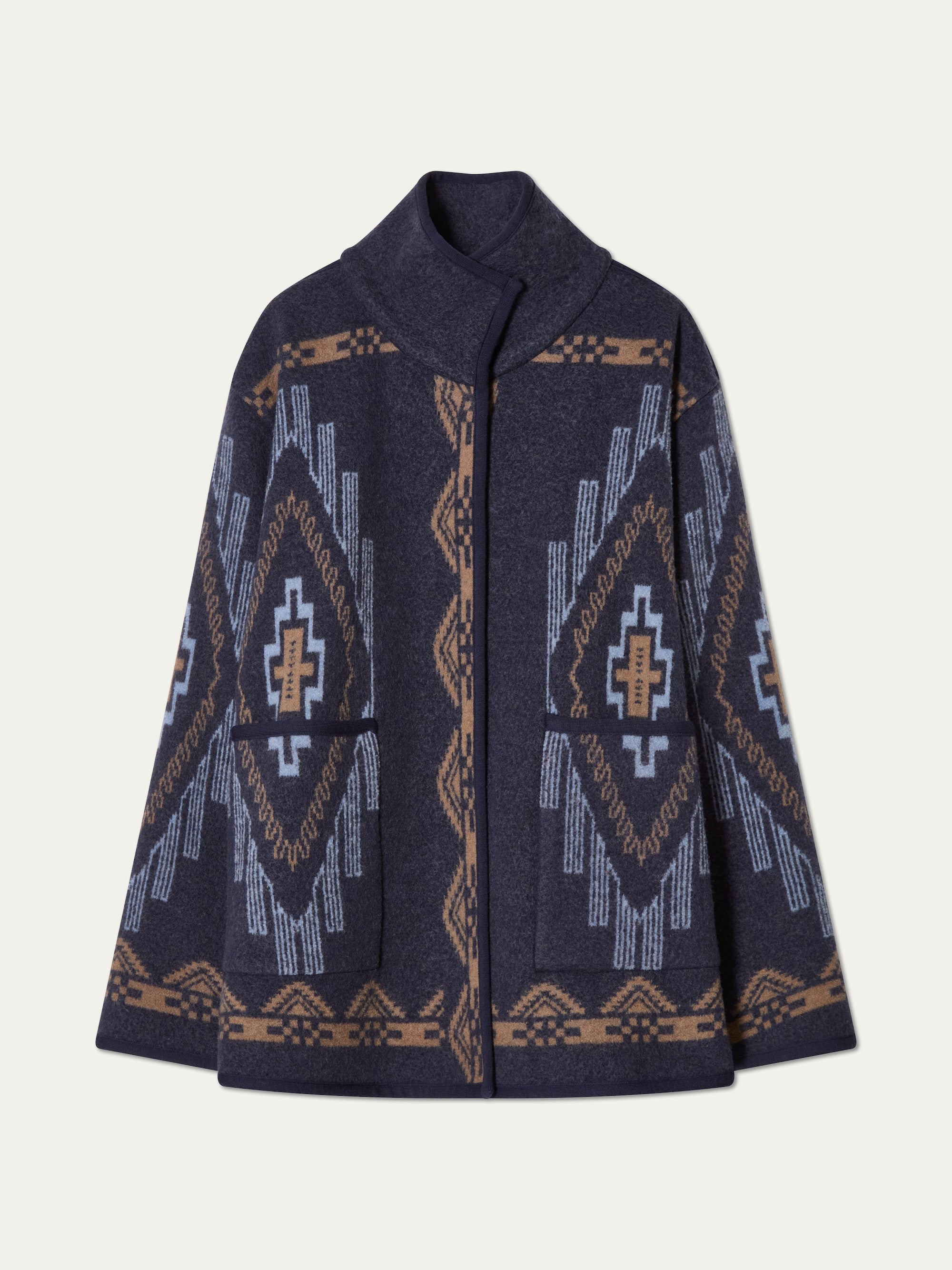 We Norwegians_FW25_Womens | Photograph of Kautokeino jacket in Navy blue | The jacket has a bold jacquard pattern inspired by Native and Indigenous American art | Comes with Snap button opening and large front pockets
