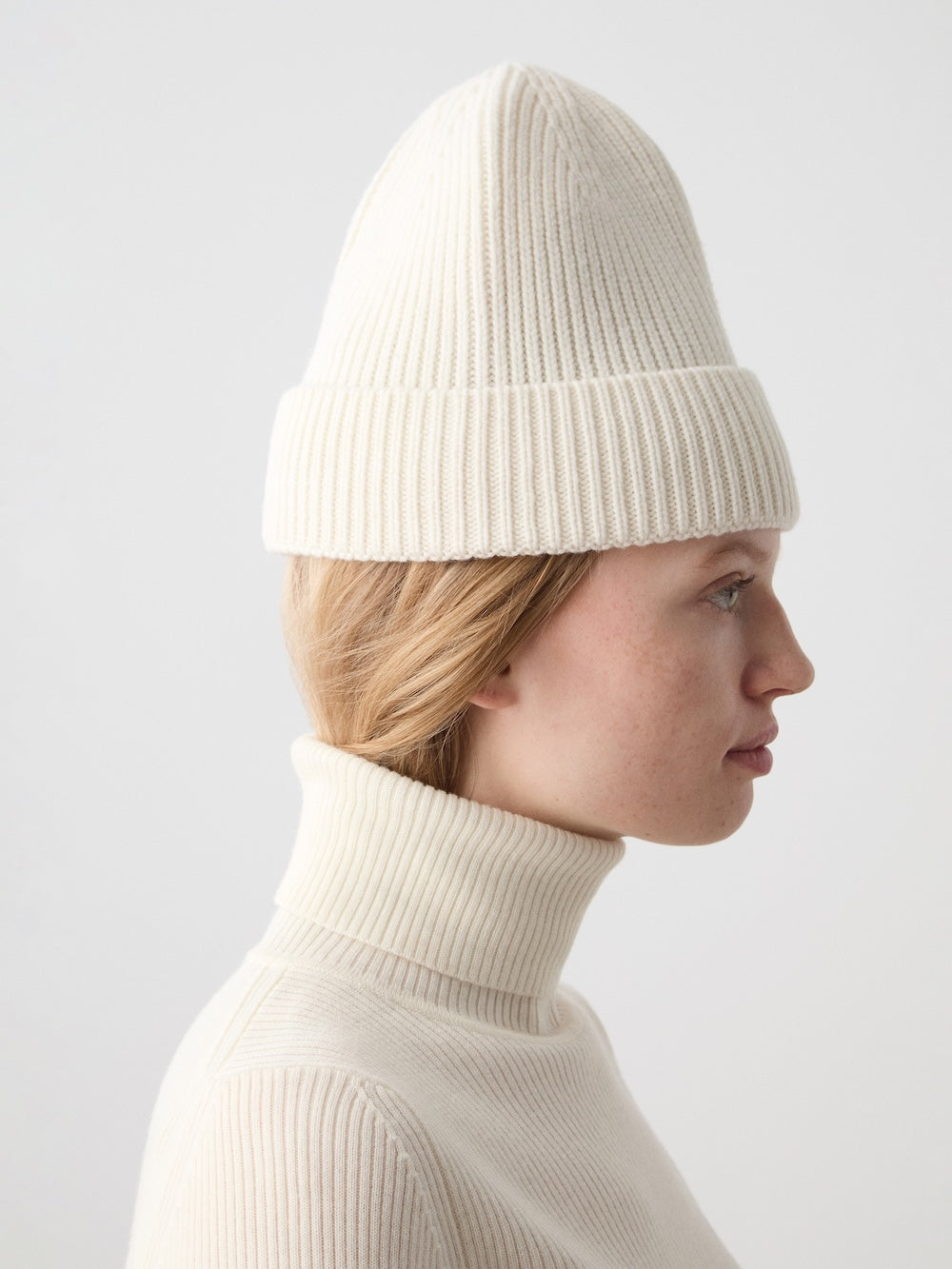 We Norwegians | FW25 | Dal Hat | Model wearing a knit beanie in off-white against an off-white background