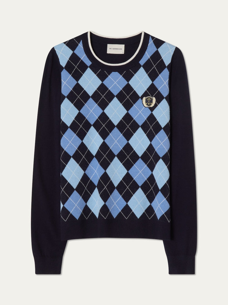 Navy sweater with blue argyle pattern on an off white background