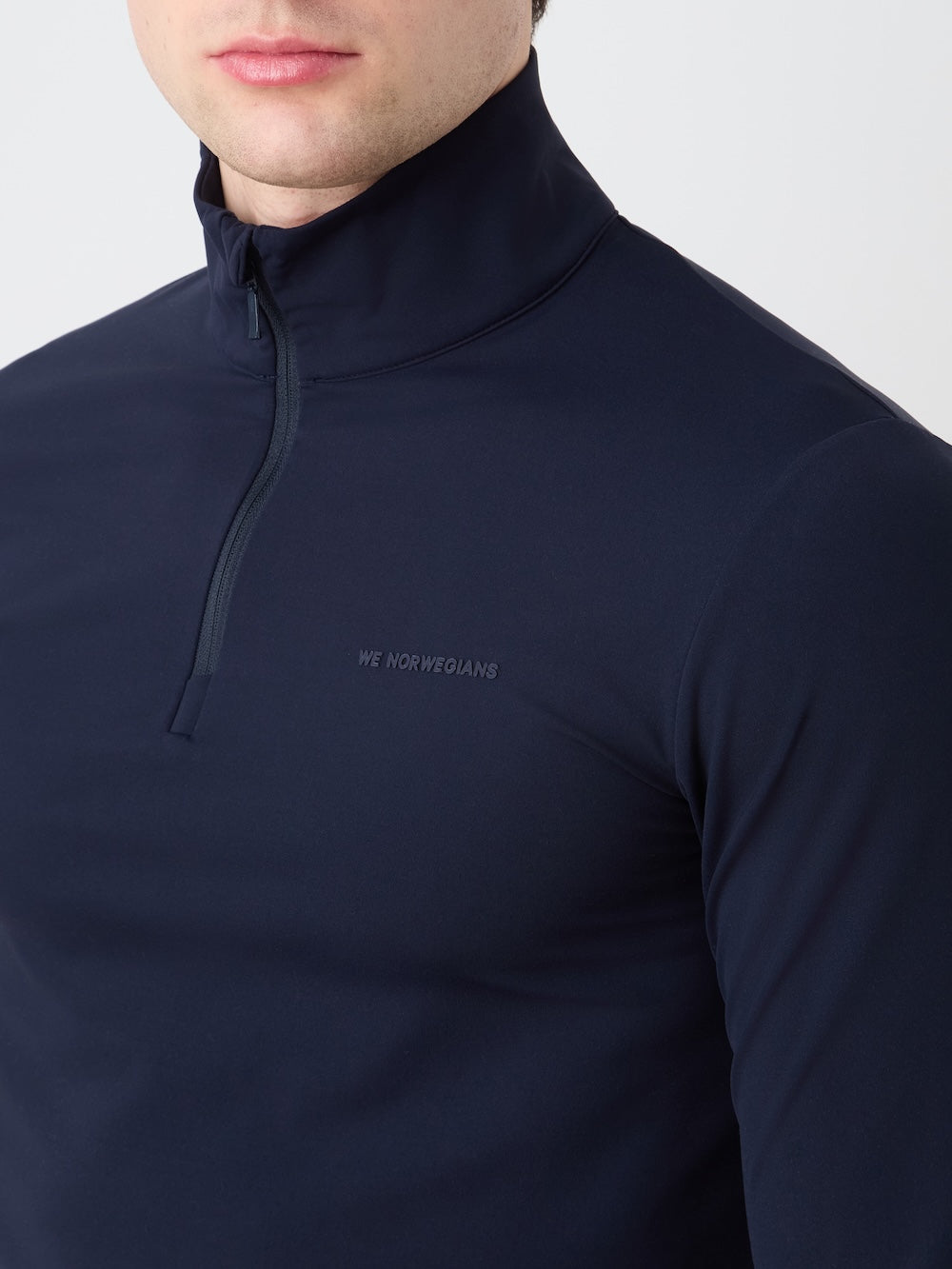 Navy blue pullover with a brand logo on a light background