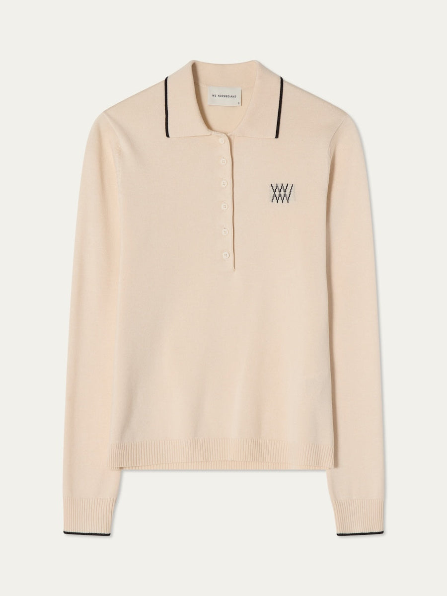 Beige long sleeved polo with black details on an off white background