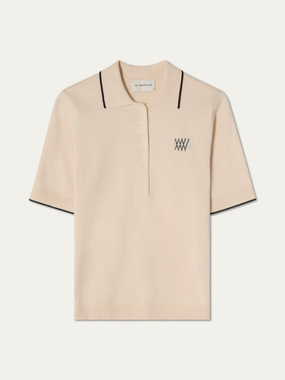 Beige polo shirt with black details on an off white background
