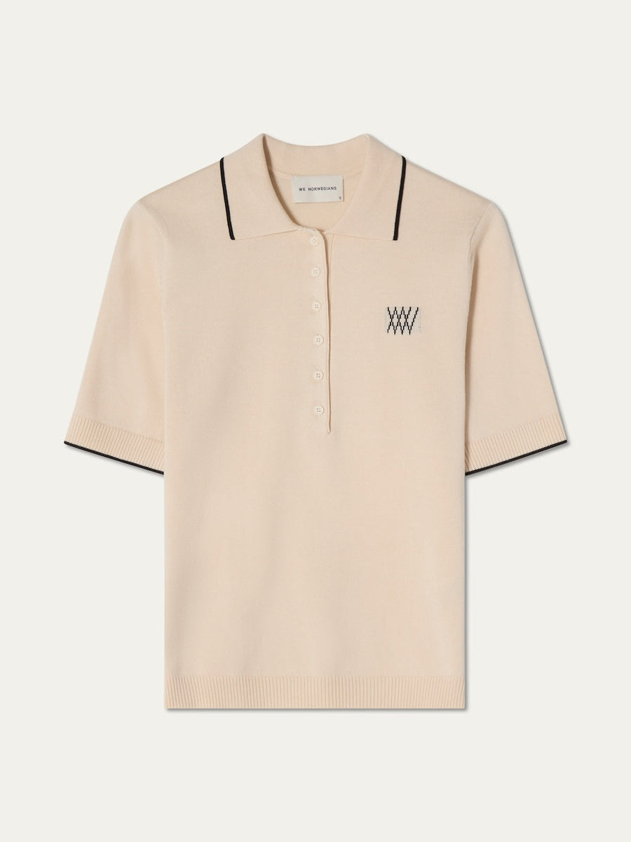 Beige polo shirt with black details on an off white background