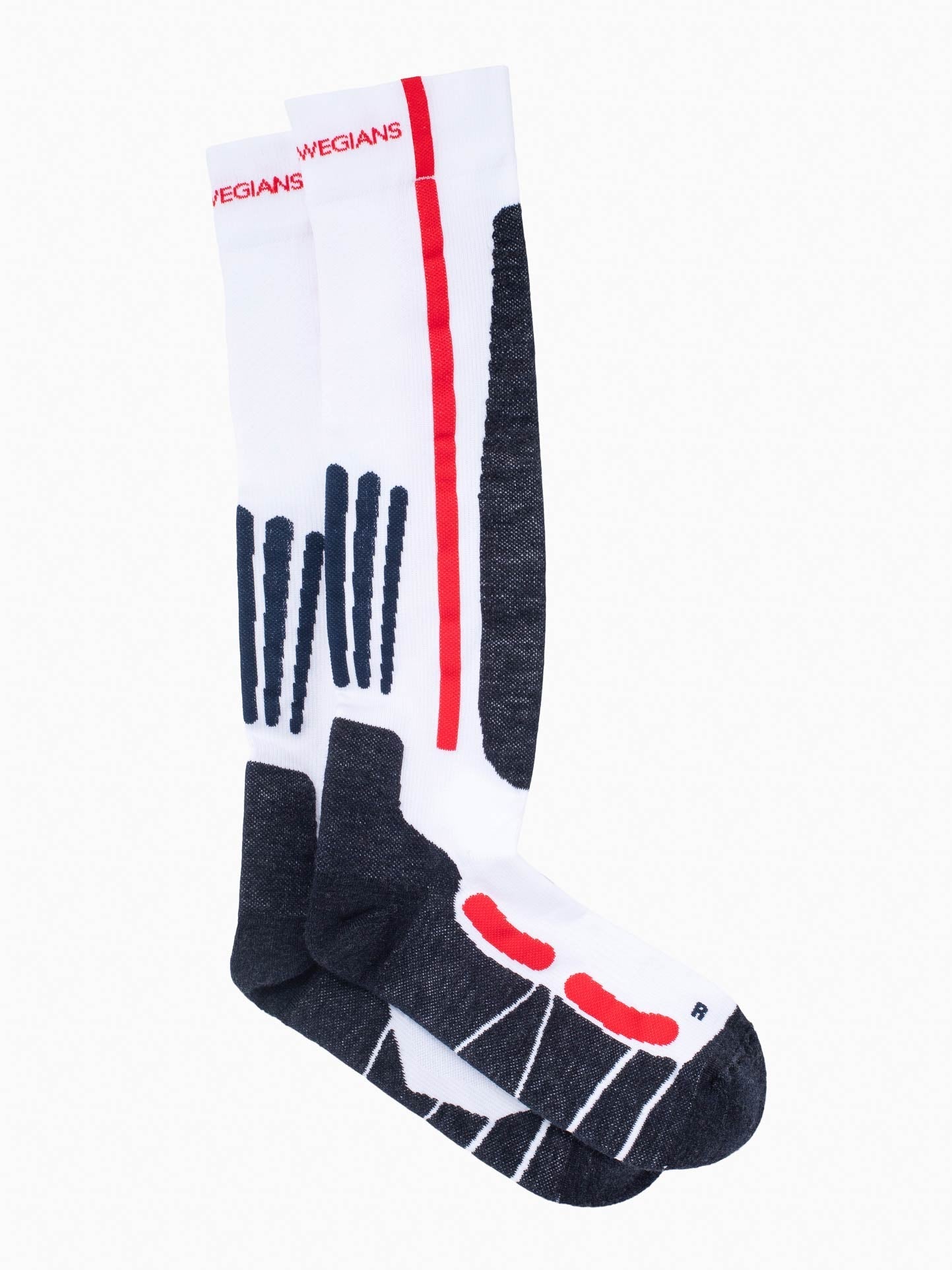 The Rocky Ski Socks by We Norwegians are unisex wool-knit, knee-high sports socks. They feature abstract geometric designs in black, white, and red with a prominent vertical red stripe and stylized patterns on a white background, offering seamless style and comfort for skiing.